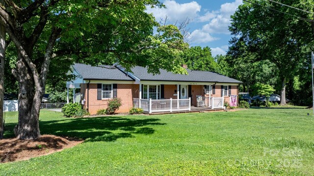 135 Burton Hills Cir, Gastonia, NC 28054 - ranch-style house with a porch, brick siding, a front yard, and roof with shingles