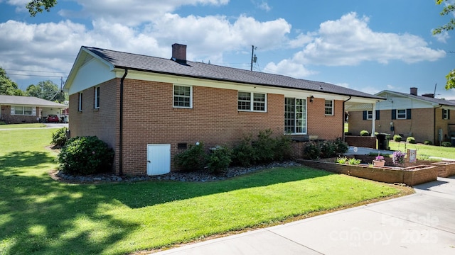 135 Burton Hills Cir, Gastonia, NC 28054 - back of house with brick siding, a lawn, and a chimney