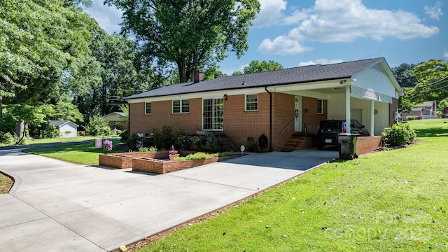 135 Burton Hills Cir, Gastonia, NC 28054 - view of front facade with concrete driveway, a carport, a front yard, brick siding, and a chimney