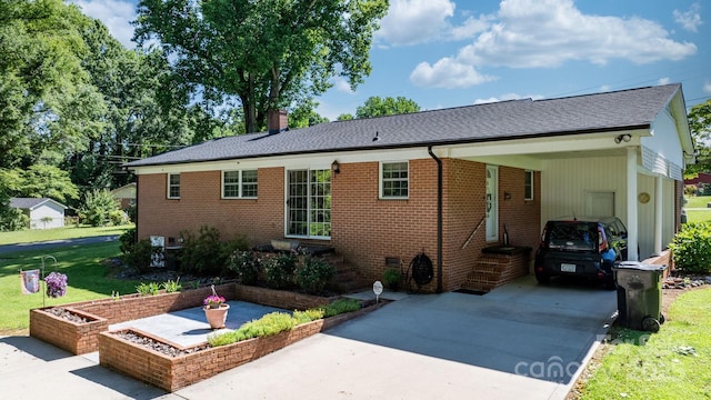 135 Burton Hills Cir, Gastonia, NC 28054 - view of front of house with concrete driveway, a carport, brick siding, and a chimney