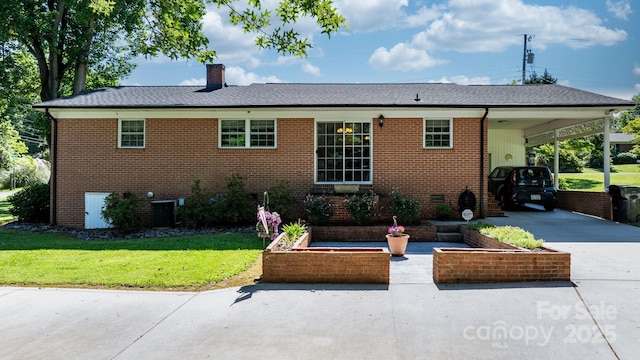 135 Burton Hills Cir, Gastonia, NC 28054 - rear view of house with concrete driveway, a lawn, brick siding, and an attached carport