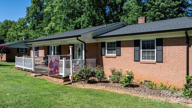 135 Burton Hills Cir, Gastonia, NC 28054 - single story home featuring a front lawn, brick siding, covered porch, and a chimney