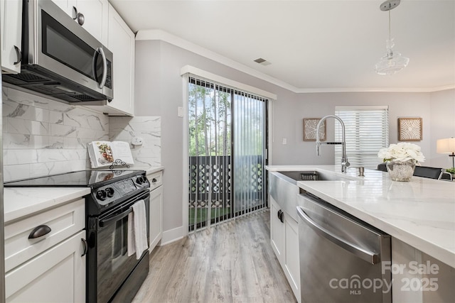 8135 Cedar Glen Dr, Charlotte, NC 28212 - kitchen with appliances with stainless steel finishes, white cabinets, decorative backsplash, light stone counters, and decorative light fixtures