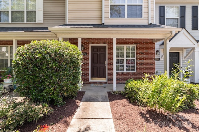 12516 Hennigan Place Ln, Charlotte, NC 28214 - doorway to property with brick siding and a porch