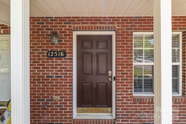 12516 Hennigan Place Ln, Charlotte, NC 28214 - doorway to property featuring brick siding and covered porch