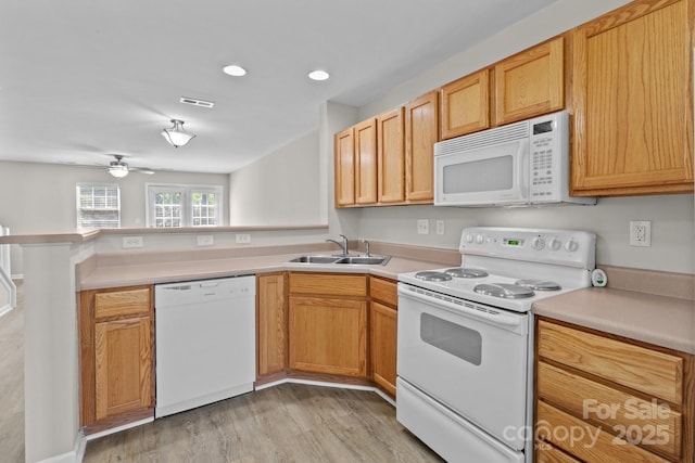 12516 Hennigan Place Ln, Charlotte, NC 28214 - kitchen with white appliances, a peninsula, light wood-style flooring, light countertops, and a ceiling fan