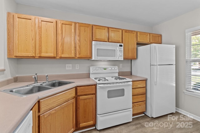 12516 Hennigan Place Ln, Charlotte, NC 28214 - kitchen with white appliances, light countertops, and light wood-style floors