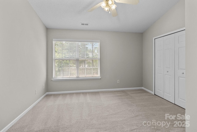 12516 Hennigan Place Ln, Charlotte, NC 28214 - unfurnished bedroom with carpet flooring, a closet, ceiling fan, and a textured ceiling