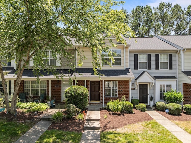 12516 Hennigan Place Ln, Charlotte, NC 28214 - view of property featuring brick siding and roof with shingles