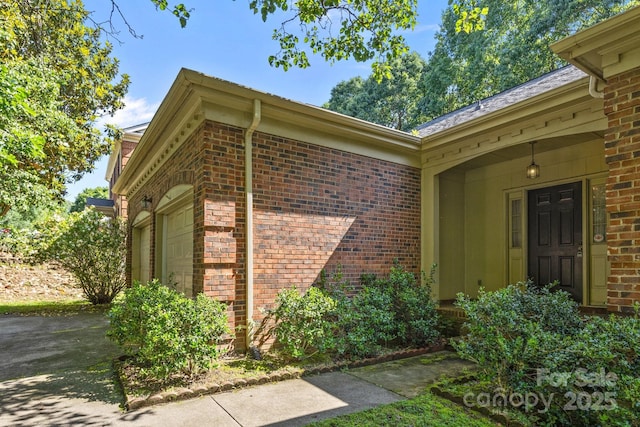212 Foxfield Ln, Matthews, NC 28105 - view of side of property featuring an attached garage and brick siding
