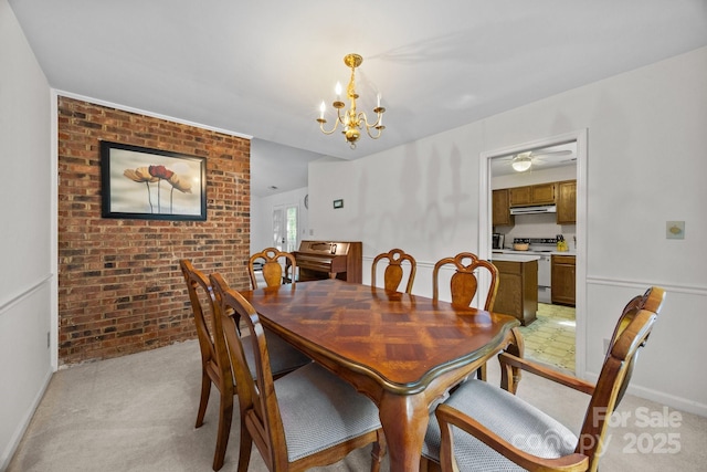 212 Foxfield Ln, Matthews, NC 28105 - dining space with a chandelier, light carpet, and brick wall