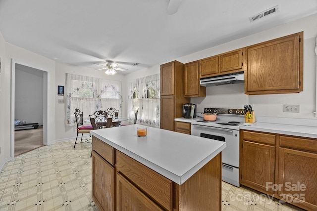 212 Foxfield Ln, Matthews, NC 28105 - kitchen featuring white range with electric cooktop, ceiling fan, under cabinet range hood, and light floors