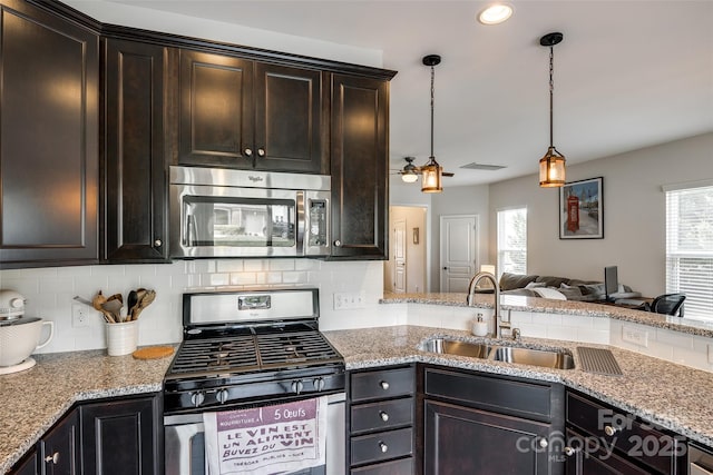 4107 Park S Station Blvd, Charlotte, NC 28210 - kitchen with appliances with stainless steel finishes, backsplash, open floor plan, light stone counters, and pendant lighting