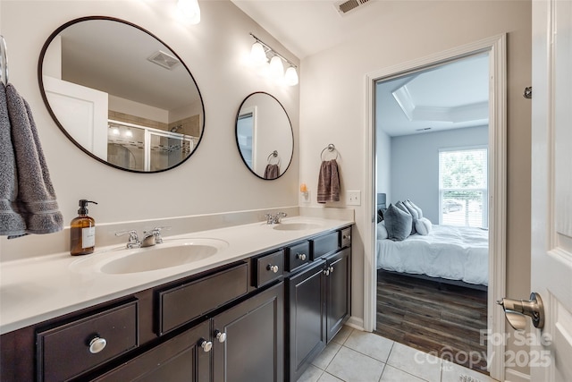 4107 Park S Station Blvd, Charlotte, NC 28210 - bathroom with double vanity, tile patterned flooring, connected bathroom, an enclosed shower, and a raised ceiling