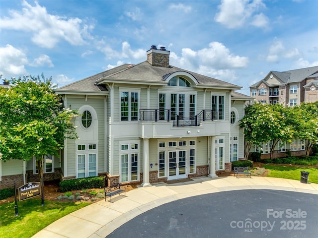 4107 Park S Station Blvd, Charlotte, NC 28210 - rear view of property with a balcony, french doors, a chimney, a patio, and brick siding
