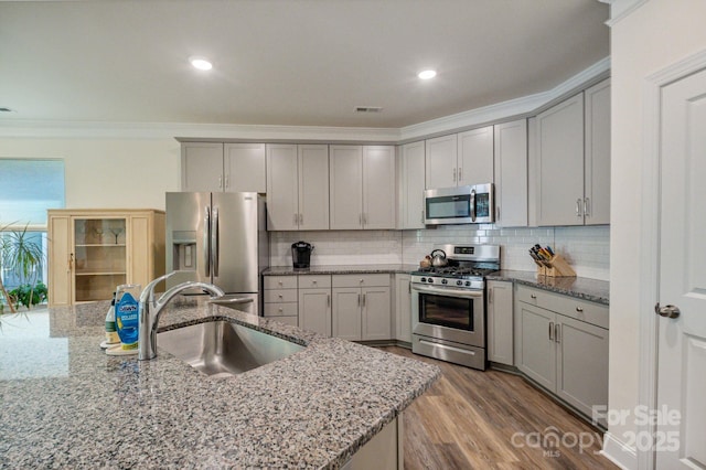 8042 Saluda Dr Unit 3, Charlotte, NC 28269 - kitchen with stainless steel appliances, ornamental molding, gray cabinetry, light stone countertops, and recessed lighting