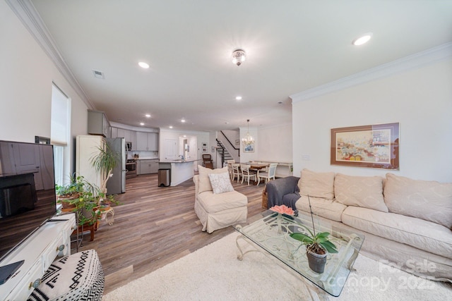 8042 Saluda Dr Unit 3, Charlotte, NC 28269 - living area featuring crown molding, stairway, recessed lighting, wood finished floors, and a chandelier