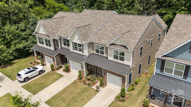8042 Saluda Dr Unit 3, Charlotte, NC 28269 - view of front facade with a garage, a standing seam roof, driveway, roof with shingles, and a front lawn