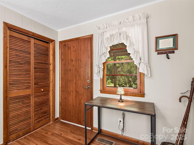 185 Indian Springs Rd, Clyde, NC 28721 - entrance foyer featuring crown molding, wood finished floors, a textured ceiling, and wood walls