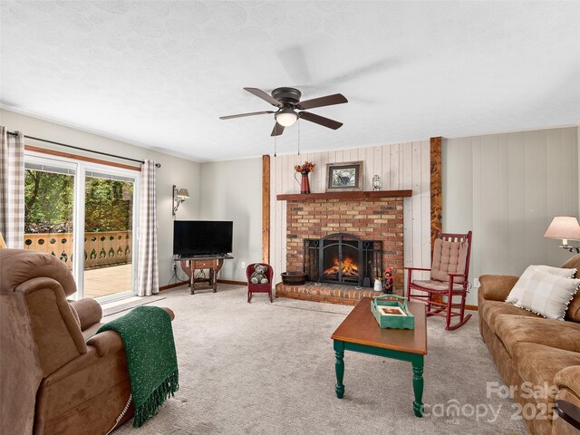 185 Indian Springs Rd, Clyde, NC 28721 - living room featuring ceiling fan, a fireplace, and carpet floors