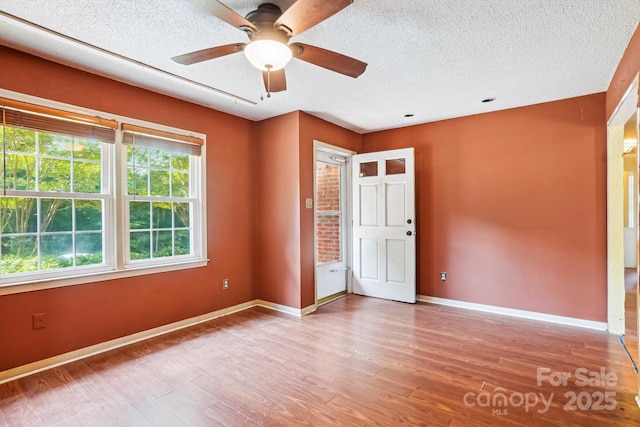 8706 Richardson King Rd, Waxhaw, NC 28173 - unfurnished bedroom with wood finished floors, a textured ceiling, and a ceiling fan
