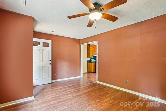 8706 Richardson King Rd, Waxhaw, NC 28173 - unfurnished room featuring ceiling fan, light wood-type flooring, and a textured ceiling