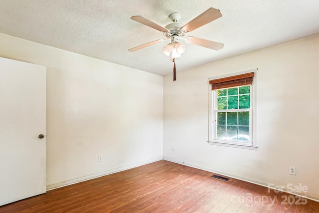 8706 Richardson King Rd, Waxhaw, NC 28173 - empty room featuring wood finished floors, ceiling fan, and a textured ceiling