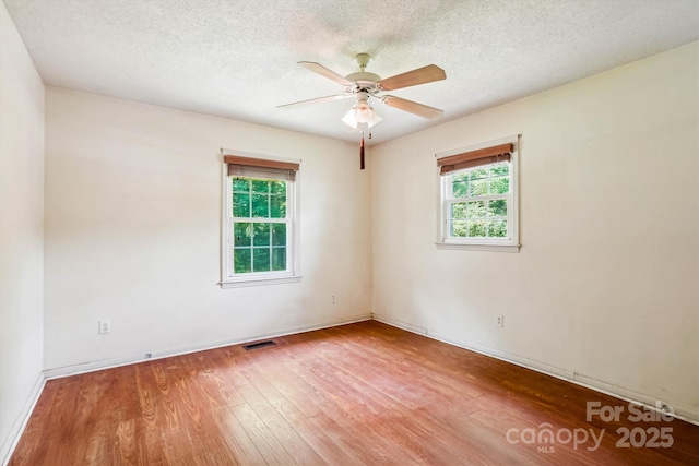 8706 Richardson King Rd, Waxhaw, NC 28173 - empty room featuring wood finished floors, ceiling fan, and a textured ceiling