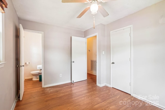 8706 Richardson King Rd, Waxhaw, NC 28173 - unfurnished bedroom featuring wood finished floors, a ceiling fan, and ensuite bath