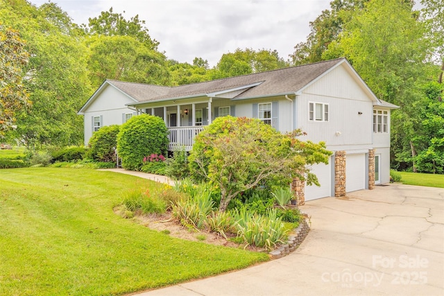 76 Woodland Hills Rd, Asheville, NC 28804 - view of front of home featuring an attached garage, concrete driveway, a front lawn, and stone siding