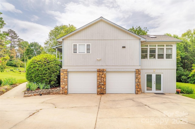 76 Woodland Hills Rd, Asheville, NC 28804 - view of side of property featuring driveway, stone siding, french doors, and an attached garage