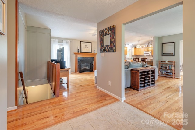 76 Woodland Hills Rd, Asheville, NC 28804 - hall with light wood finished floors, an upstairs landing, and a textured ceiling