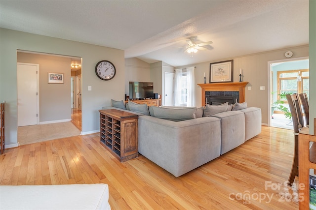 76 Woodland Hills Rd, Asheville, NC 28804 - living room with light wood finished floors, a ceiling fan, a tile fireplace, healthy amount of natural light, and vaulted ceiling