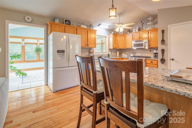 76 Woodland Hills Rd, Asheville, NC 28804 - kitchen featuring white appliances, light wood finished floors, a ceiling fan, lofted ceiling, and light stone counters