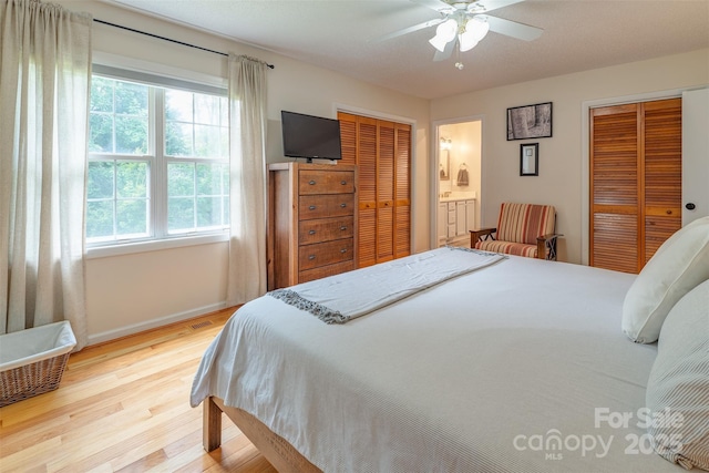 76 Woodland Hills Rd, Asheville, NC 28804 - bedroom featuring light wood-type flooring, a closet, ceiling fan, and ensuite bathroom
