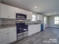 1017 W C St, Kannapolis, NC 28081 - kitchen featuring stainless steel appliances, recessed lighting, white cabinetry, and light countertops