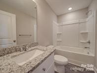 1017 W C St, Kannapolis, NC 28081 - bathroom with vanity and bathing tub / shower combination