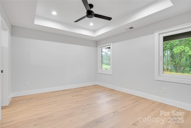 452 Duncan St, Spartanburg, SC 29306 - spare room featuring a tray ceiling, plenty of natural light, light wood-style floors, recessed lighting, and a ceiling fan