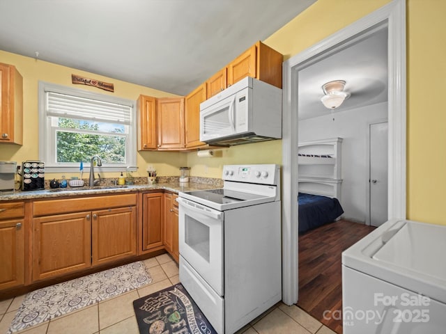 427 E 12th Ave, Gastonia, NC 28054 - kitchen featuring white appliances, light tile patterned floors, washer / clothes dryer, and light stone countertops