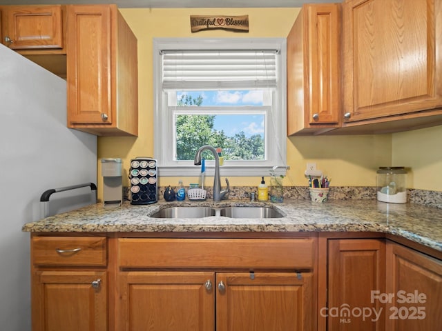 427 E 12th Ave, Gastonia, NC 28054 - kitchen featuring light stone counters and brown cabinetry