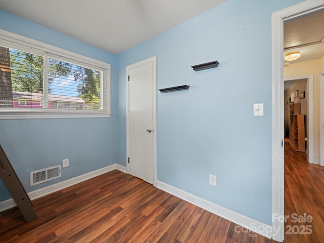 427 E 12th Ave, Gastonia, NC 28054 - unfurnished bedroom featuring baseboards and wood finished floors