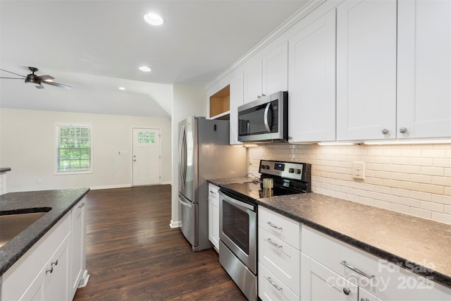 7627 Sarah Dr, Denver, NC 28037 - kitchen featuring appliances with stainless steel finishes, dark wood-type flooring, backsplash, a ceiling fan, and white cabinets