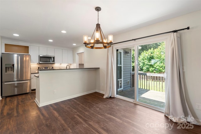 7627 Sarah Dr, Denver, NC 28037 - kitchen with appliances with stainless steel finishes, a chandelier, dark wood-style flooring, white cabinetry, and recessed lighting