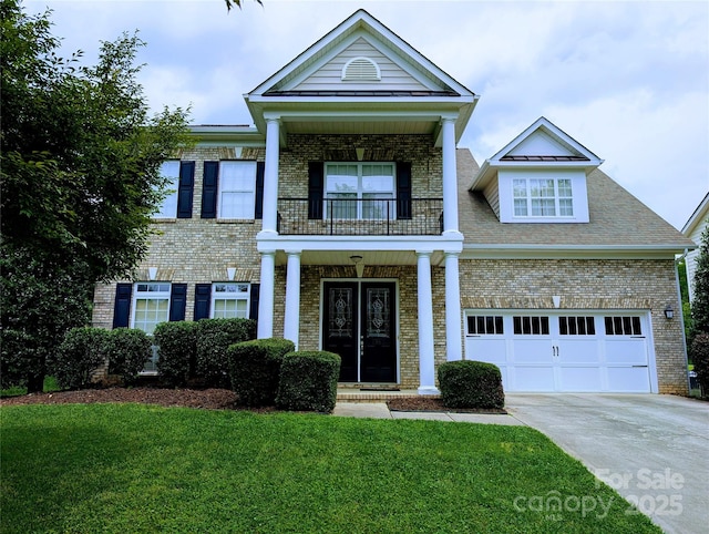 408 Presidio Dr, Rock Hill, SC 29732 - greek revival house with a balcony, concrete driveway, a front yard, brick siding, and covered porch