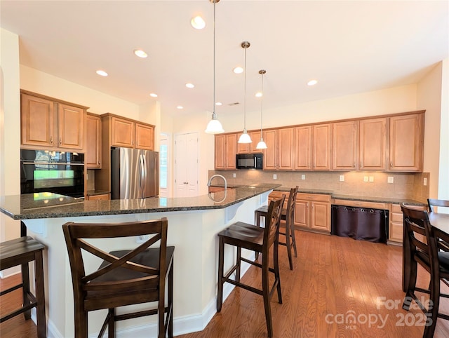 408 Presidio Dr, Rock Hill, SC 29732 - kitchen with black appliances, a breakfast bar area, decorative backsplash, light wood-style floors, and dark stone counters