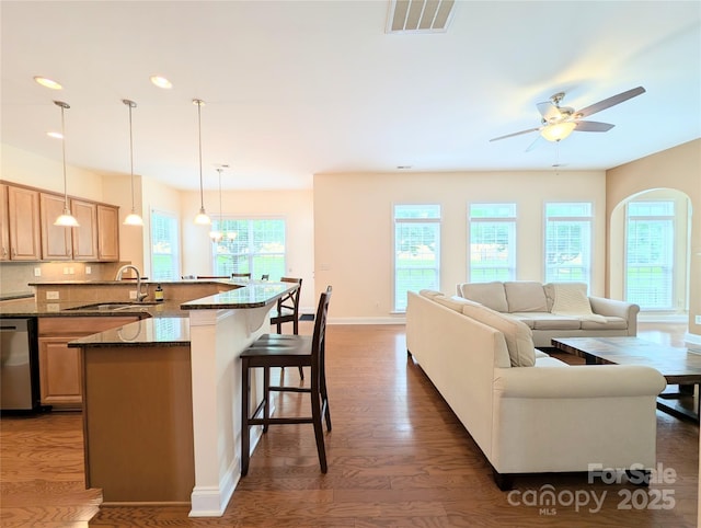 408 Presidio Dr, Rock Hill, SC 29732 - kitchen with stainless steel dishwasher, a breakfast bar area, dark wood finished floors, recessed lighting, and arched walkways