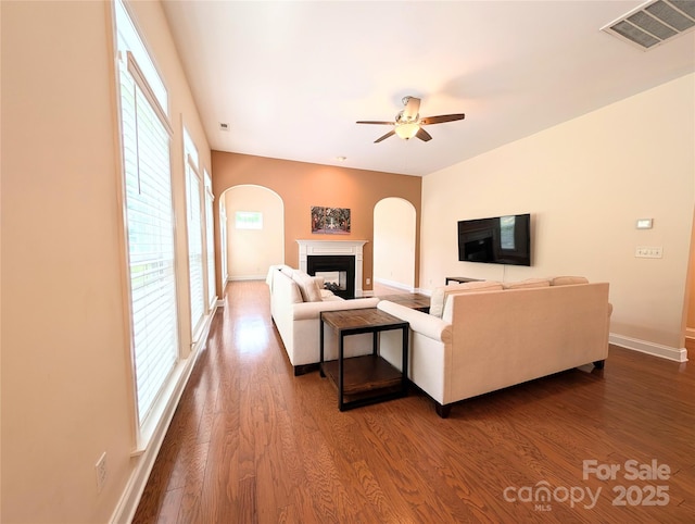 408 Presidio Dr, Rock Hill, SC 29732 - living area with arched walkways, ceiling fan, dark wood-style floors, and a fireplace