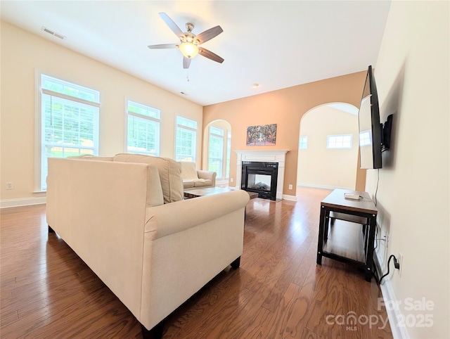 408 Presidio Dr, Rock Hill, SC 29732 - living room with arched walkways, dark wood-type flooring, a ceiling fan, and a multi sided fireplace