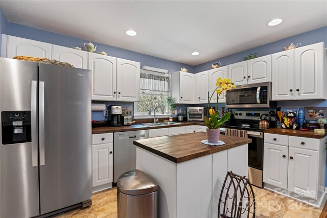 4 Orchard Pl, Weaverville, NC 28787 - kitchen featuring wood counters, appliances with stainless steel finishes, white cabinetry, a kitchen island, and recessed lighting