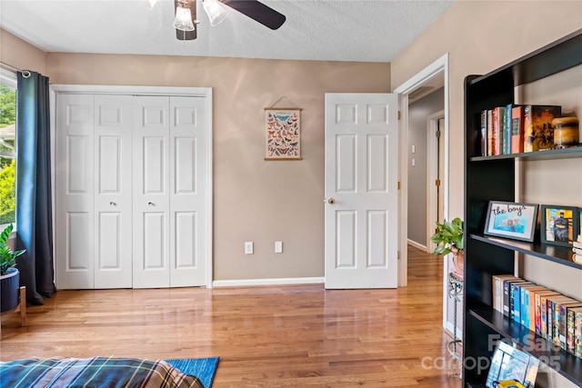 4 Orchard Pl, Weaverville, NC 28787 - bedroom with wood finished floors, a closet, a textured ceiling, and a ceiling fan
